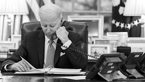 Joe Biden talks on the phone during a series of calls with congressional leaders, Monday, May 1, 2023, in the Oval Office of the White House. (Official White House photo by Adam Schultz)