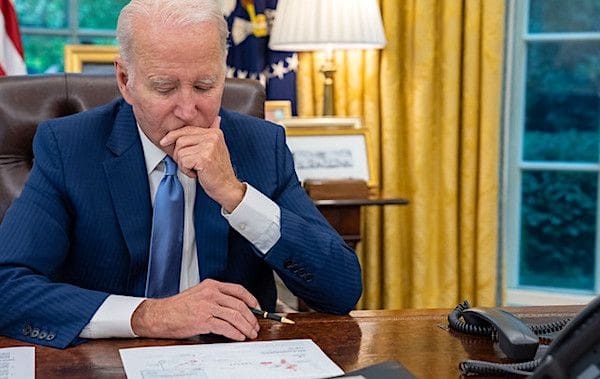 Joe Biden talks on the phone with Canadian Prime Minister Justin Trudeau in the Oval Office of the White House, Wednesday, June 7, 2023, to talk about the Canadian wildfires and the smoke blanketing parts of the U.S. (Official White House photo by Adam Schultz)