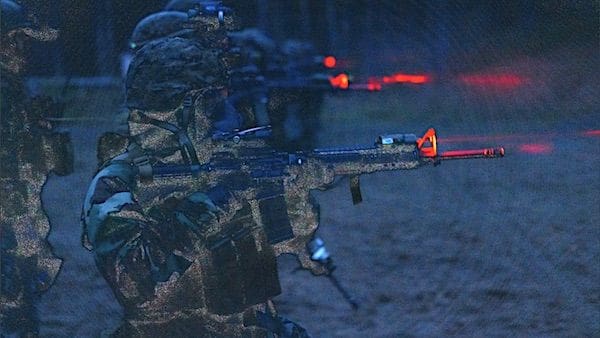 Marines fire their rifles during chemical, biological, radiological and nuclear night operations in preparation for Exercise Freezing Winds 22 in Syndalen, Finland, Oct. 13, 2022. (U.S. Marine Corps photo by Lance Cpl. Meshaq Hylton)