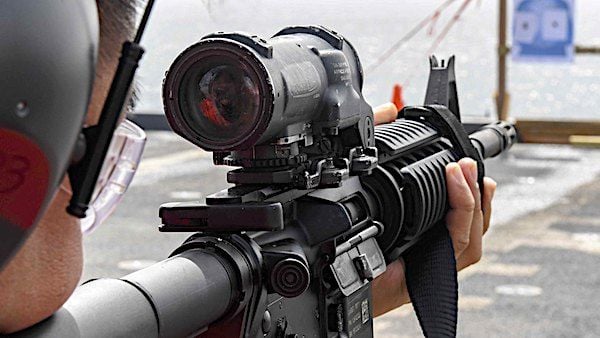 Aviation Boatswain's Mate 1st Class Leondrei Floresca aims at his target during an M4 rifle qualification course aboard the Expeditionary Sea Base USS Hershel 'Woody' Williams in the Atlantic Ocean, June 26, 2021. (U.S. Navy photo by Mass Communication Specialist 2nd Class Eric Coffer)