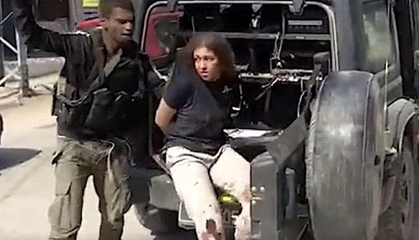 A Hamas terrorist takes a young Israeli woman hostage on Saturday, Oct. 7, 2023.