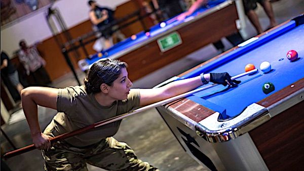 Army Sgt. Melissa Bilgen competes in the 9-ball tournament during the Captain's Cup at Camp Lemonnier, Djibouti, Oct. 25, 2021. (U.S. Navy photo by Petty Officer 2nd Class Jonathan Word)