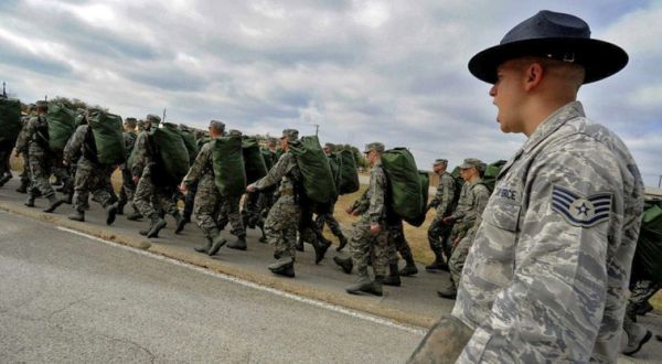 Staff Sgt. Robert George, a military training instructor at Lackland Air Force Base, Texas, marches his recruits following the issuance of uniforms and gear during basic training. (Master Sgt. Cecilio Ricardo / Air Force)