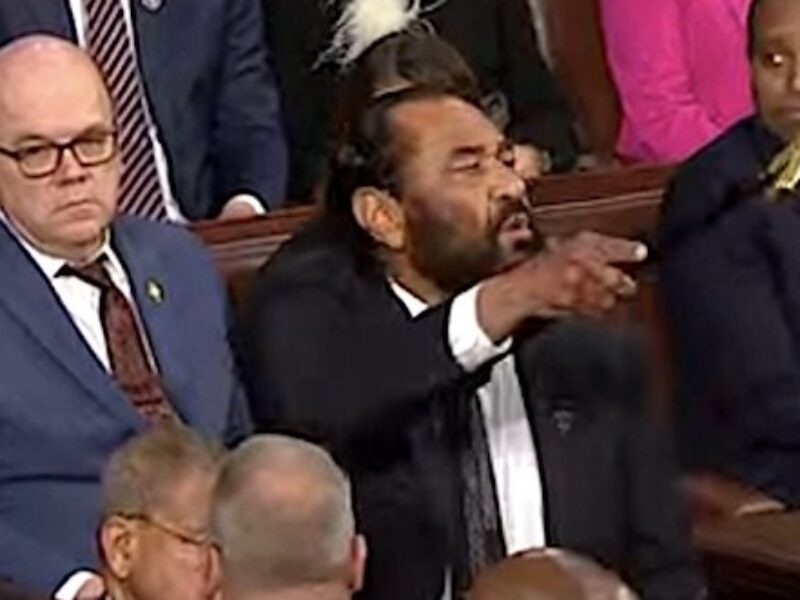 U.S. Rep. Al Green, D-Texas, shouts as he's escorted out of the House chamber