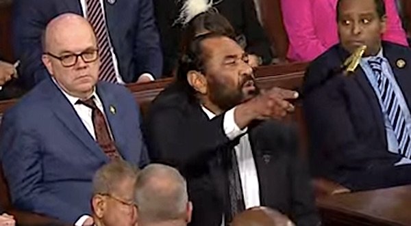 U.S. Rep. Al Green, D-Texas, shouts as he's escorted out of the House chamber