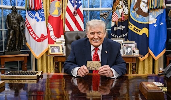 President Donald Trump displays the Trump Gold Card in the Oval Office (Official White House photo)