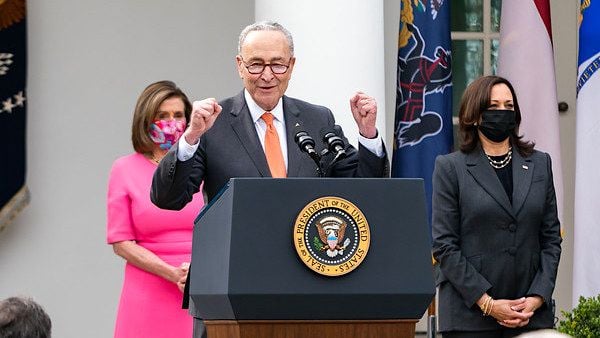 Vice President Kamala Harris and House Speaker Nancy Pelosi, D-Calif., look on as Senate Majority Leader Charles 'Chuck' Schumer, D-N.Y., delivers remarks on the American Rescue Plan Friday, March 12, 2021, in the Rose Garden of the White House. (Official White House photo by Adam Schultz)