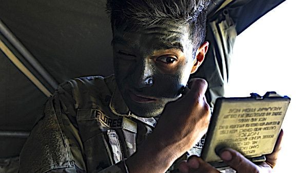 Army Spc. Christian Flores applies face paint during the U.S. Army Europe European Best Warrior Competition at Hohenfels Training Area, Germany, July 29, 2020. Winners in the annual competition go on to represent U.S. Army Europe at the Army Best Warrior Competition. (U.S. Army photo by Spc. Austin Riel)